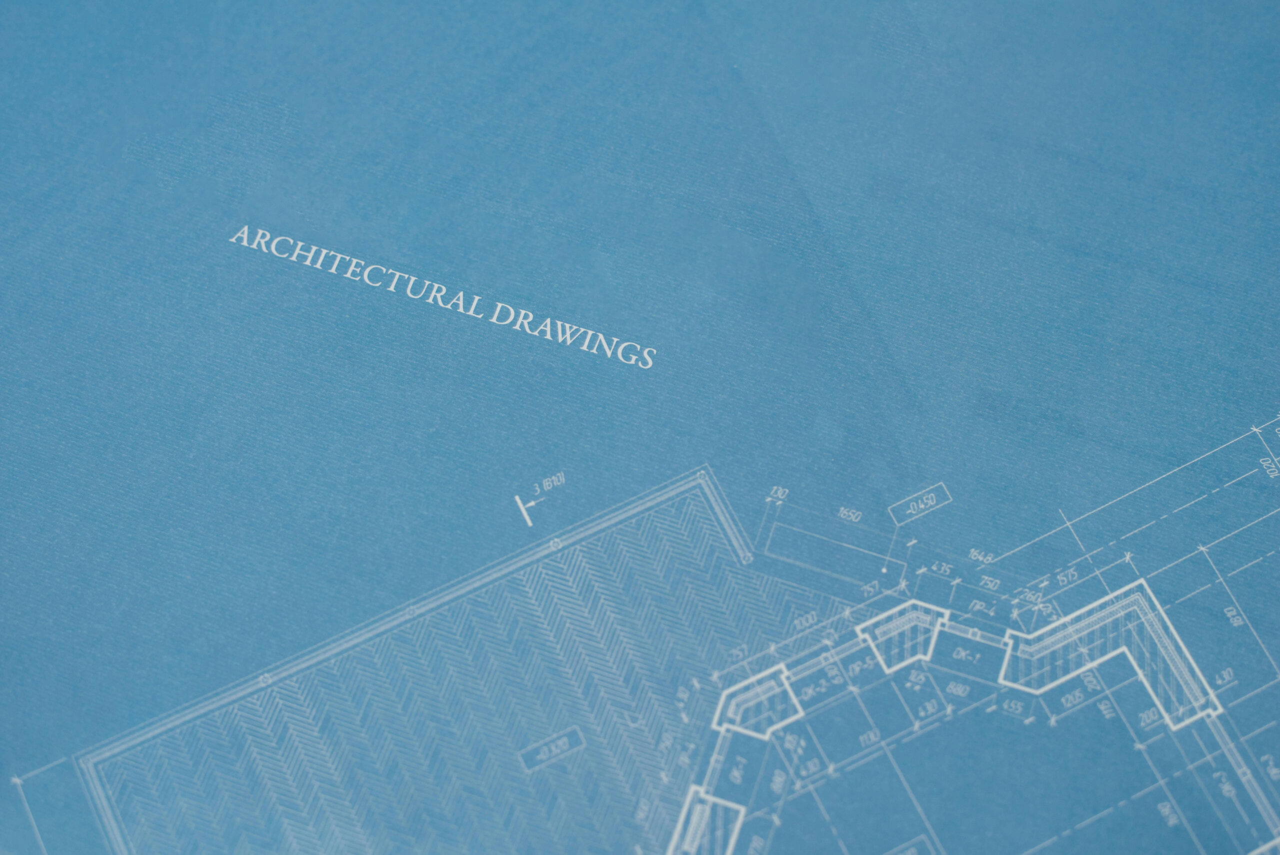 Architectural drawings on a blueprint, showcasing detailed planning and design, representing the concept of blueprint basics for construction projects.