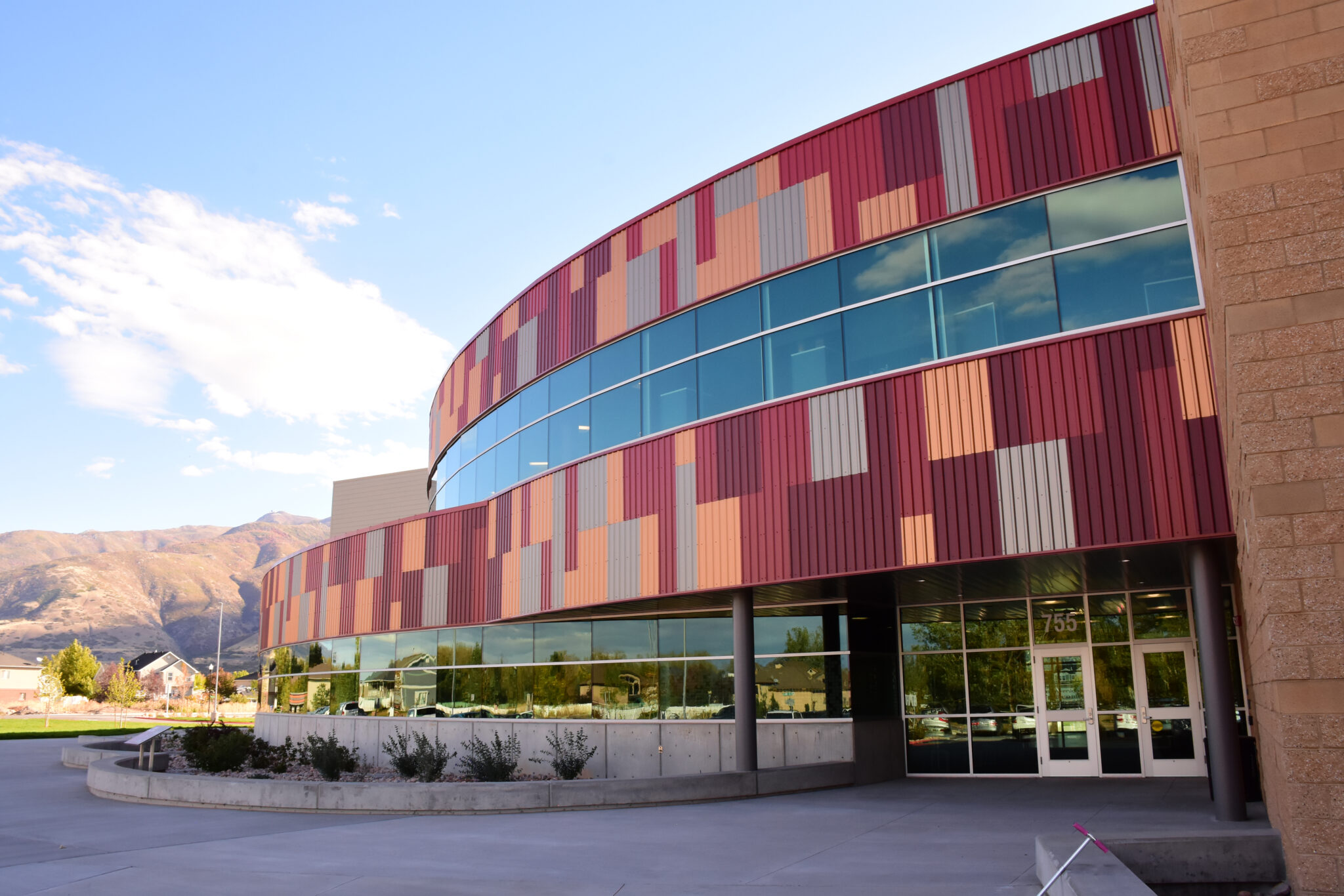 Canyon Creek Elementary School with a sleek, modern design featuring large windows and a colorful exterior.